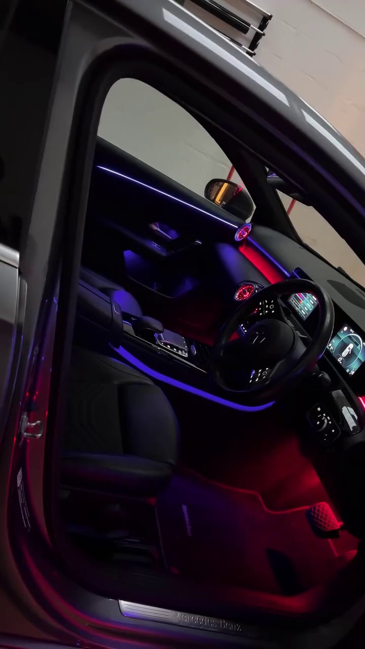 Red and purple ambient lighting in a Mercedes cabin