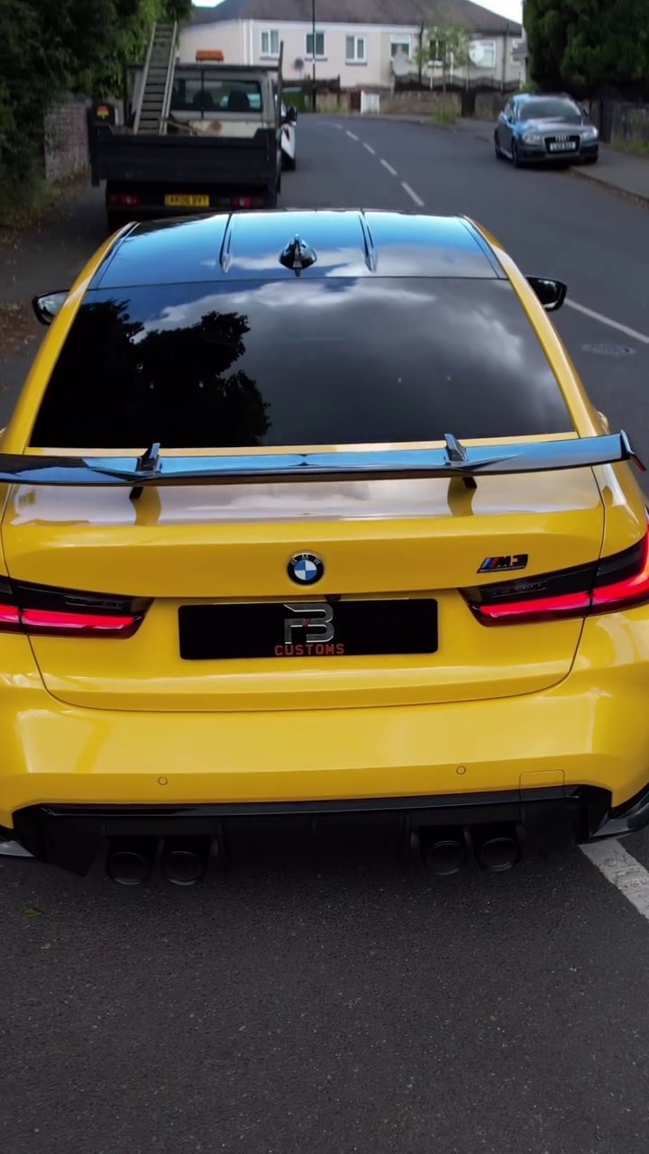 Rear view of a yellow BMW M3