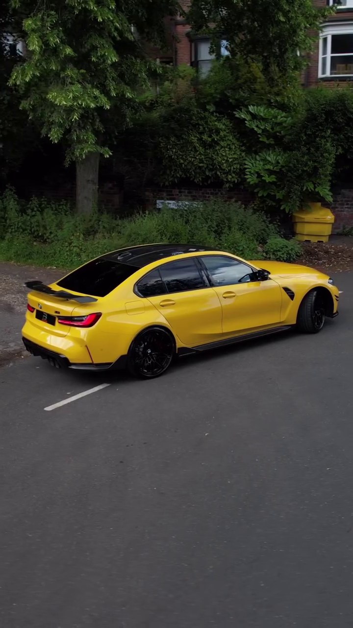 Side view of a yellow BMW M3