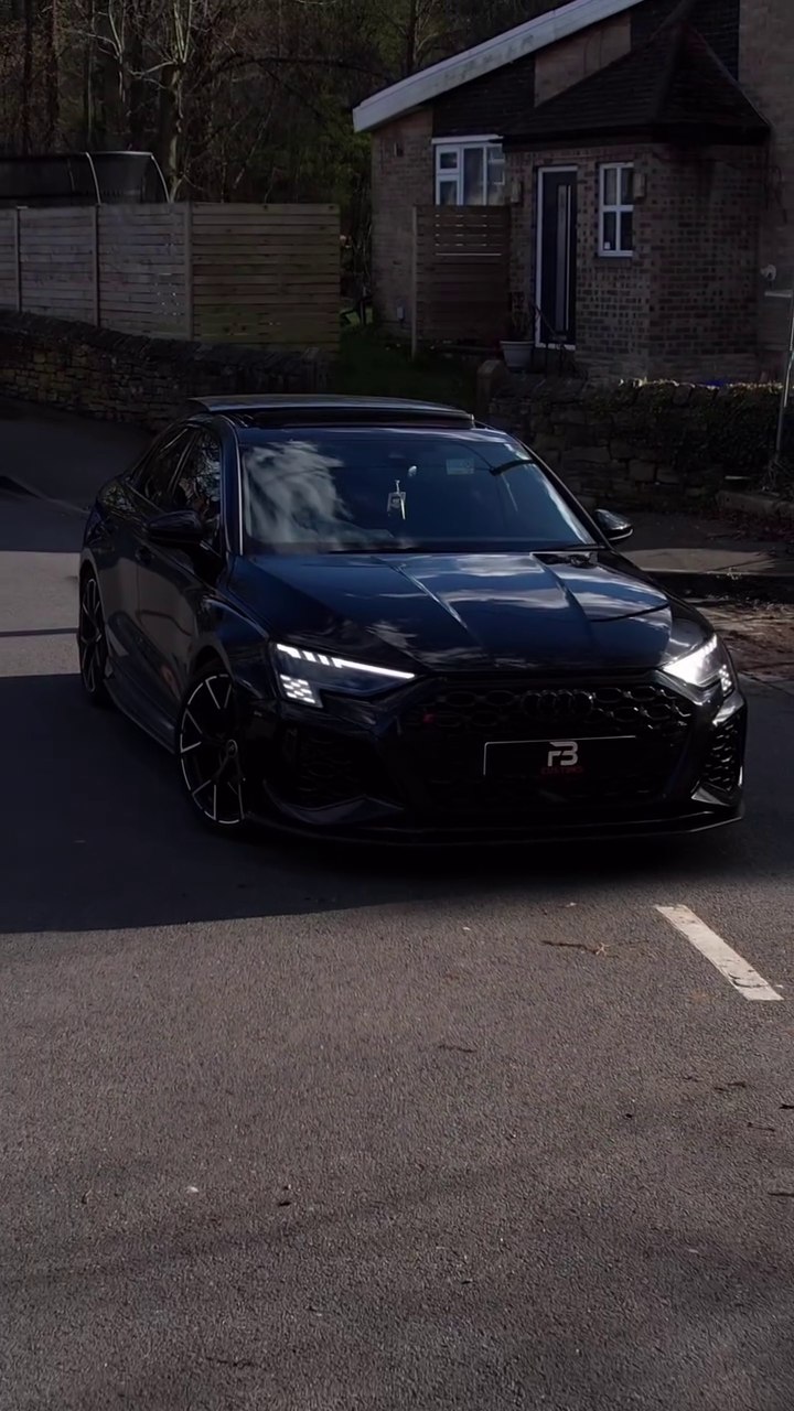 Black Audi photographed from the front on a street