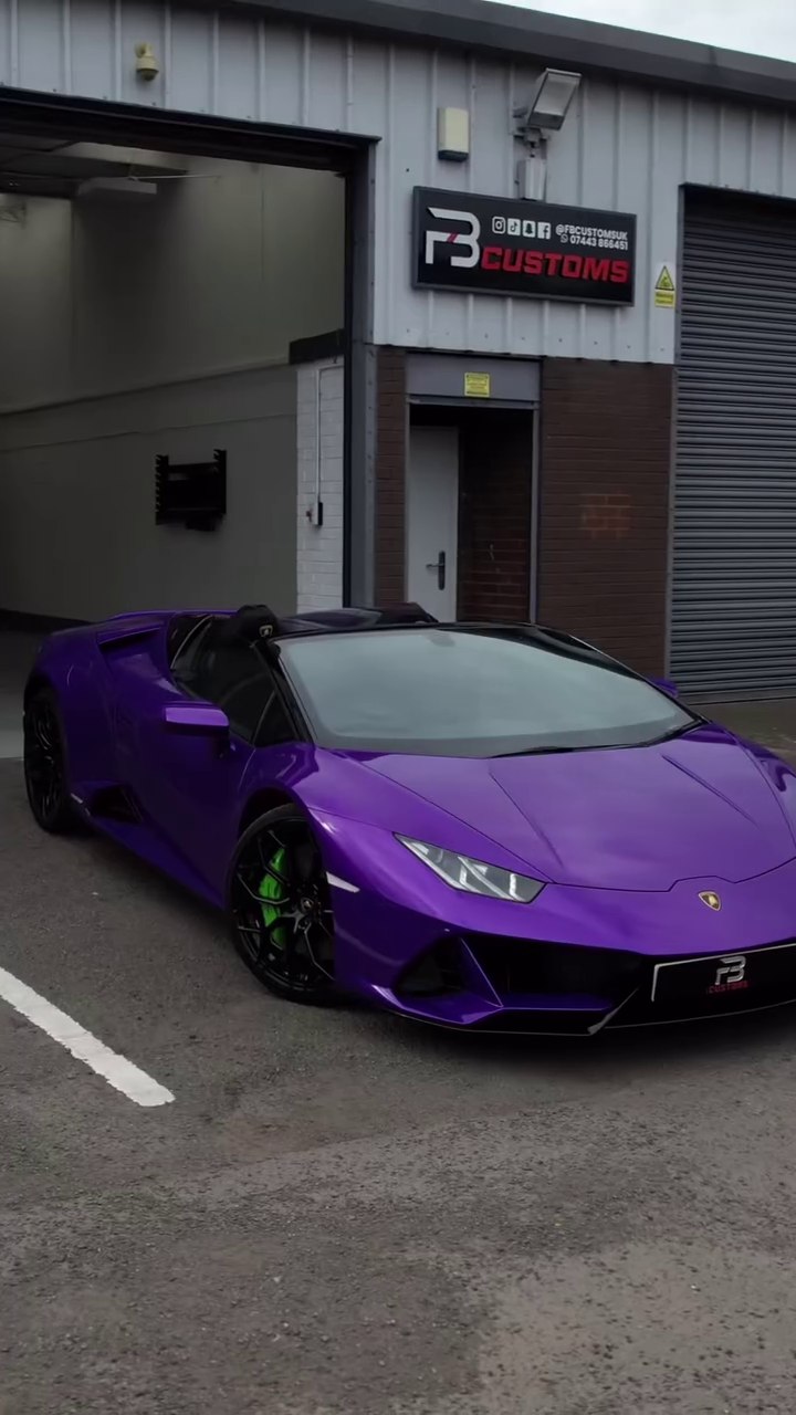 Front angle of a purple Lamborghini outside the workshop