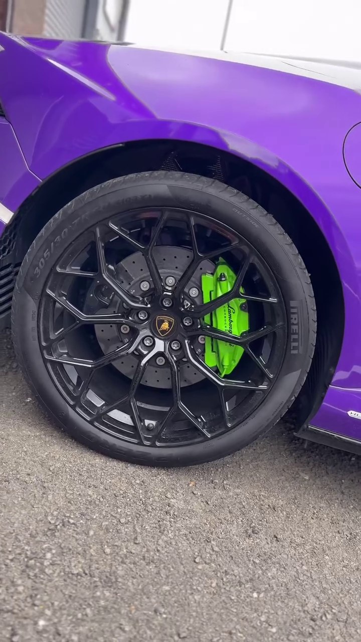 Black Lamborghini wheel with a green brake caliper