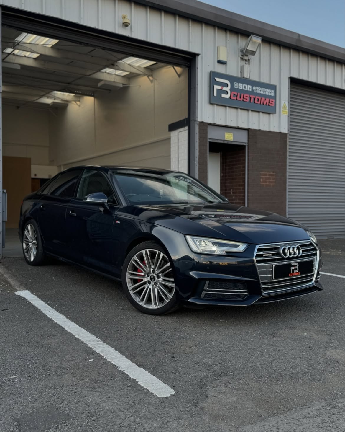 Dark blue Audi outside the FB CUSTOMS workshop