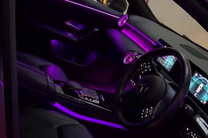 Purple ambient lighting across a vehicle interior